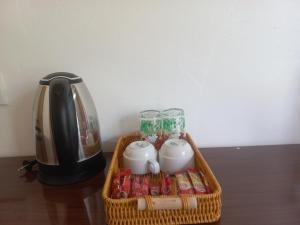 a wicker basket with a coffee maker and drinks at Dhigurah Holidays in Dhigurah +46 photos