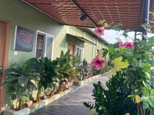 a building with flowers and plants in front of it at Road Trip Retreat in Belagula +11 photos