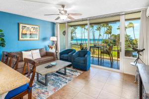 a living room with a couch and a table at Island Surf 304 - Renovated, Ocean Views, Split AC in Kihei