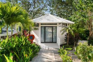a small white house with trees and plants at Blue Ridge Retreat in Potrero