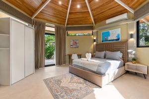 a bedroom with a large bed with a wooden ceiling at Blue Ridge Retreat in Potrero