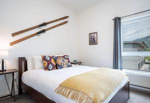 a bedroom with a bed and a large window at The First Tracks Flat in Revelstoke
