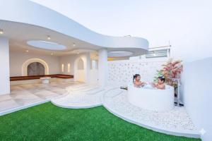 two women in a bath tub in a house at The Pool Space - ICONIC Pool Villa in Ban Huai Yai