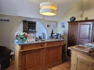 a kitchen with a large island in a room at Hôtel Le Niobel in Belgodère