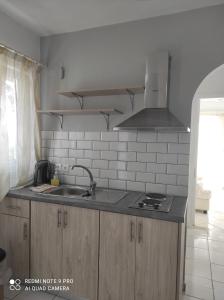 a kitchen with a sink and a stove at Nafsika Sea View Apartments in Kerveli +35 photos