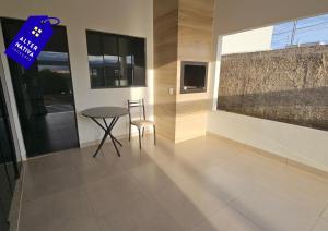 a dining room with a table and two chairs at Casa Coqueiro 02 in Primavera do Leste