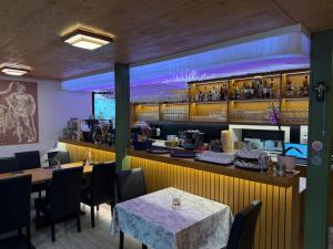a restaurant with a bar with tables and chairs at Dionysos Traube in Rottweil