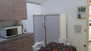 a kitchen with a refrigerator and a microwave at 't Vliethuys in Zwijndrecht +9 photos