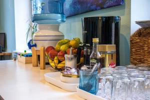 a counter top with a bowl of fruit and a blender at Central Hostel in Riga