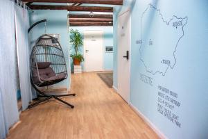 a room with a hammock on a wall next to a door at Central Hostel in Riga