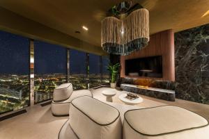 a living room with a view of a city at night at Sky Tower Apartamenty - In The Sky Apartments in Wrocław