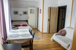 a small room with two beds and a couch at Noclegi U Asi in Polańczyk