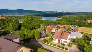 an aerial view of a town with houses and a lake at Noclegi U Asi in Polańczyk
