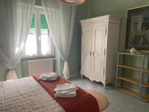 a bedroom with a bed with towels on it at Casa Diana in Tarquinia
