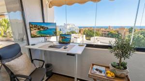 an office with a desk with a laptop and a window at La Cala Center Premium Penthouse Motorized Terrace & Sea Views in La Cala de Mijas +15 photos