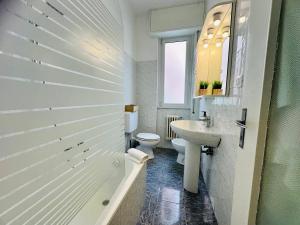 a white bathroom with a toilet and a sink at Piccolo Rifugio by anbra Properties --- WITH PARKING AND FREE WIFI in Rapallo +24 photos