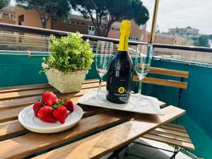 a table with two glasses of wine and strawberries at Piccolo Rifugio by anbra Properties --- WITH PARKING AND FREE WIFI in Rapallo