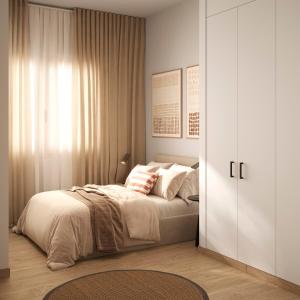 a bedroom with a bed and a sliding door at Lumen Mare Malvarrosa by SH Hoteles in Valencia