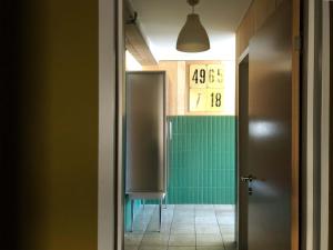 a bathroom with a urinal and a green wall at Tsar Bani Spa Resort in Gudauri