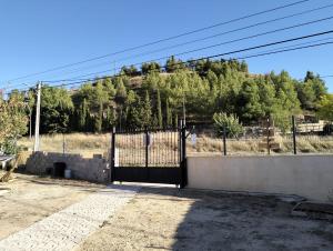 a gate in a fence with a mountain in the background at Casa Valle del Hontanar in Cardenete