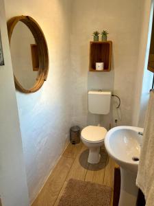 a bathroom with a white toilet and a sink at Green Hollow Self catering in Knysna +10 photos