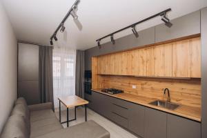 a living room with a couch and a kitchen at 2 кім кв BIG APARTMENT TOP Center in Sumy