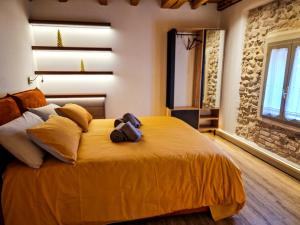 a bedroom with a yellow bed with a camera on it at Il Rivellino in Marostica