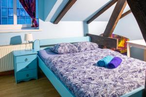 a bedroom with a blue bed with two pillows at Central Hostel in Riga