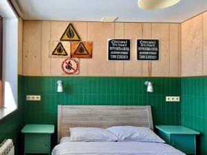 a bedroom with a bed and signs on the wall at Tsar Bani Spa Resort in Gudauri
