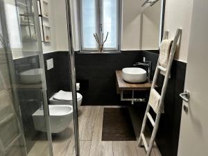 a bathroom with a toilet and a sink and a shower at My Home Lainate Historic Center in Lainate