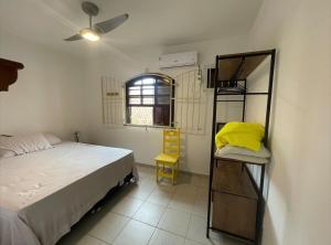 a bedroom with a bed and a bunk bed with a window at Casa com 2 suítes com ar in Cabo Frio