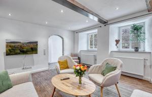 a living room with two chairs and a table at Munkler Mühle Whg 1 in Irrhausen