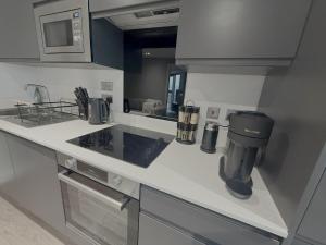 a kitchen with a coffee maker on a counter at Stunning Albert Dock Penthouse in Liverpool