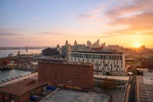a view of a city skyline with the sun setting at Stunning Albert Dock Penthouse in Liverpool