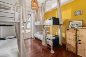 a bedroom with two bunk beds and a window at Jaca Hostel Porto da Cruz in Porto da Cruz +68 photos