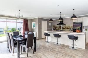 a kitchen and dining room with a table and chairs at Contemporary Methven Abode in Methven