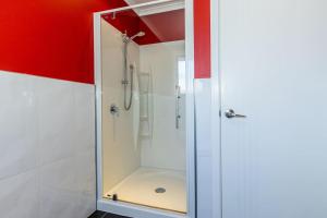 a shower with a glass door in a bathroom at Contemporary Methven Abode in Methven +14 photos