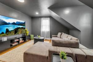 a living room with a couch and a tv at Central location Parking in Cheektowaga