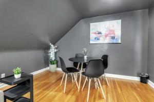 a dining room with a table and chairs at Central location Parking in Cheektowaga