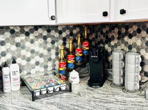 a bunch of bottles of alcohol on a kitchen counter at Central location Parking in Cheektowaga +15 photos