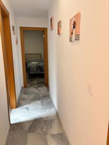 a hallway with a room with a bed and a mirror at Alojamientos CASTILLA-AGAVE in Tabernas