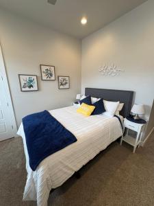 a bedroom with a large bed with blue and white sheets at Kantada in the Sun - Poolside Retreat in Santa Clara +43 photos