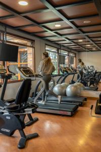 a gym with cardio equipment and people on treadmills at Hotel Habitel Prime in Bogotá