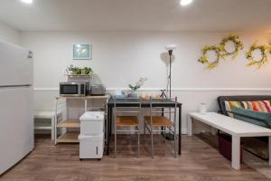 a small kitchen with a table and a couch at Comfy Private Basement- Scarborough in Toronto