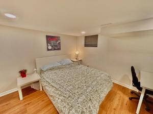 a bedroom with a bed and a desk and a chair at Comfy Private Basement- Scarborough in Toronto