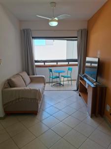 a living room with a couch and a table at Ap Orla de Aracaju in Aracaju