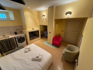 a bedroom with a white bed and a red chair at Il "Nido di Achille" in Centro - 2 piani di privacy e massimo comfort! in Terni