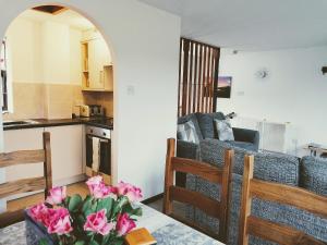 a living room with a couch and a kitchen at Capstan Cottage in Whitby