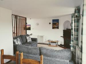 a living room with a couch and a table at Capstan Cottage in Whitby