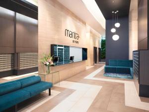 a lobby of a mica office with blue couches at Mantra on Mary in Brisbane +42 photos